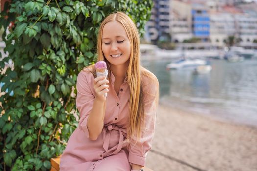 Close up of pretty tourist girl eating traditional gelato italian ice cream in a European town.