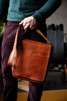 close-up photo of orange leather bag corporate. indoor photo