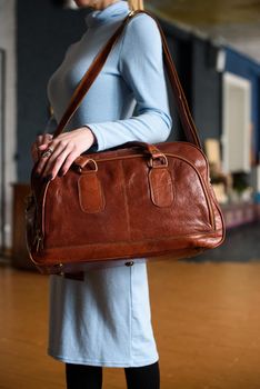 close-up photo of orange leather bag corporate. indoor photo