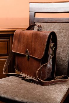 brown leather briefcase with antique and retro looks for man. indoor photo