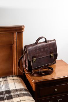 Brown leather briefcase in a cell with two locks. hotel room photo.