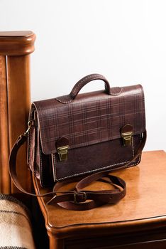 Brown leather briefcase in a cell with two locks. hotel room photo.