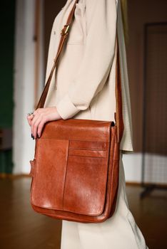 close-up photo of orange leather bag corporate. indoor photo