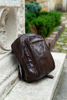 Brown leather backpack on the snone monument.