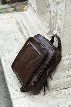 Brown leather backpack on the snone monument.