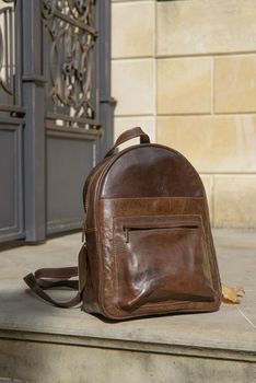 Brown leather backpack on the snone monument.