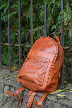 Orange leather backpack on the snone monument.