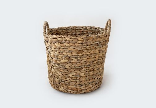 Rural wicker basket isolated on white background. Handmade craft traditional bag made from natural materials