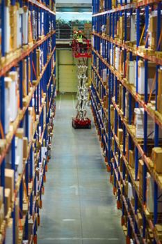 Blur warehouse background. Warehouse worker taking package in the shelf in a large warehouse in a large warehouse.