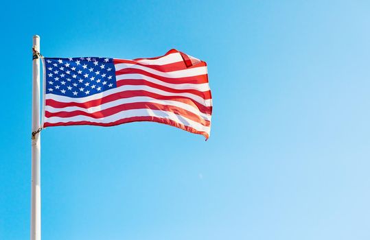 Low angle shot of the American flag standing on its own outside during the day.