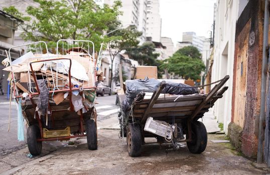 Shot of carts full of garbage in the street of a poor neighbourhood.
