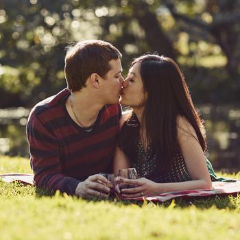 Shot of an affectionate young couple having a romantic picnic in the park.