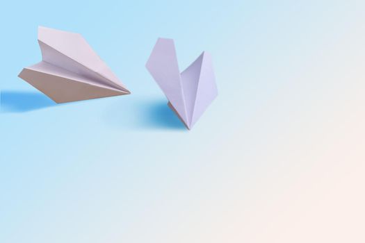 two paper planes on a white background.