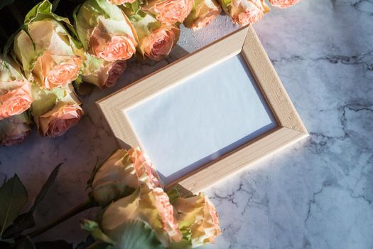 gold picture frame with decorations. Mock up for your photo or text Place your work, print art, roses in vase