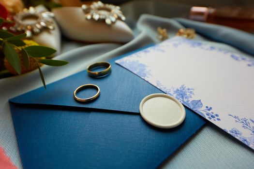 Wedding rings and wedding invitation. Shallow dof.