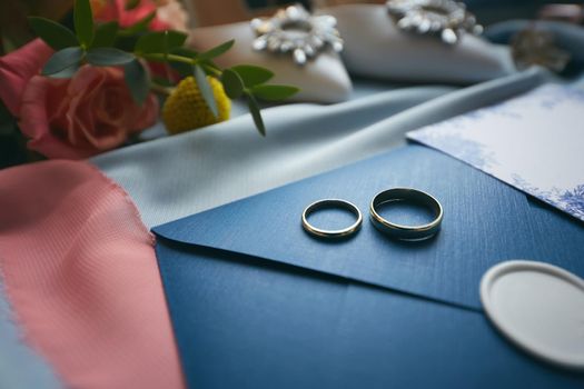 Wedding rings and wedding invitation. Shallow dof.