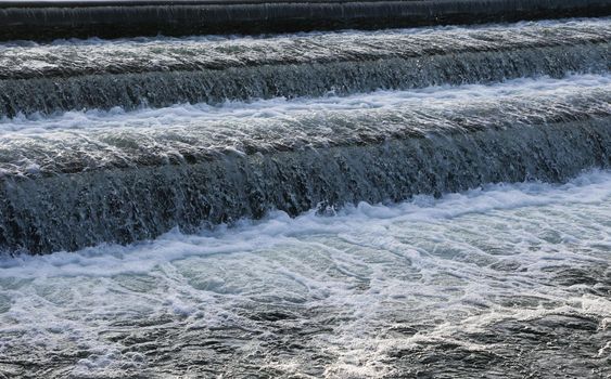 A close-up of a waterfall descending from a lake.