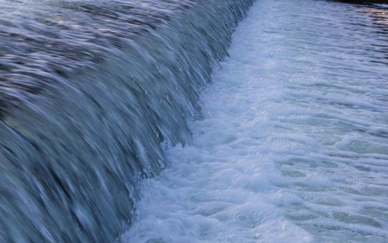 Downward flow of water from a body of water.