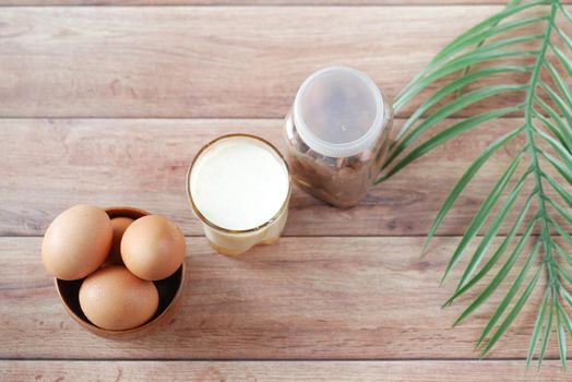 eggs in a bow and a glass of milk on table ,