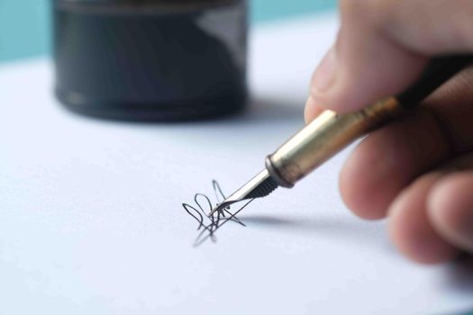 Close up of man hand writing a letter with fountain pen.
