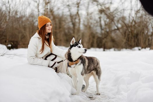 woman winter outdoors with a dog fun nature fresh air. High quality photo