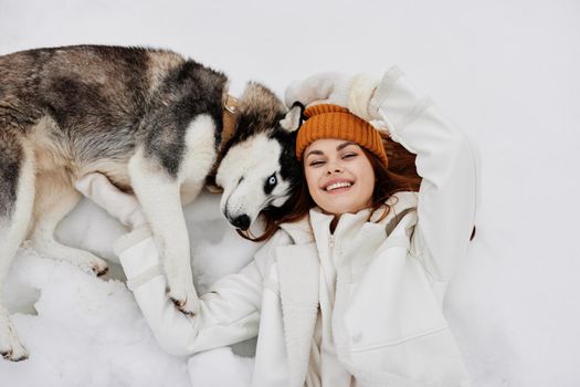 woman winter clothes walking the dog in the snow Lifestyle. High quality photo