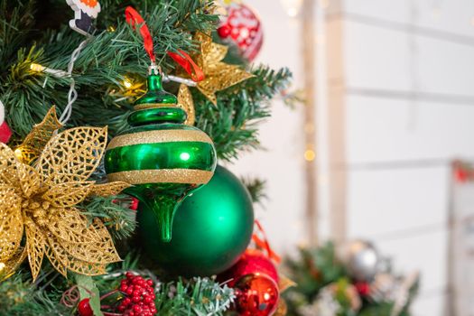 Christmas balls hanging on snowy fir tree