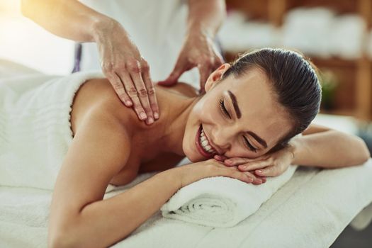 Shot of an attractive young woman getting massaged at a beauty spa.