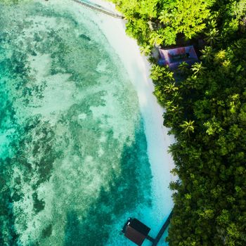 High angle shot of a clear blue ocean touching the coastline.