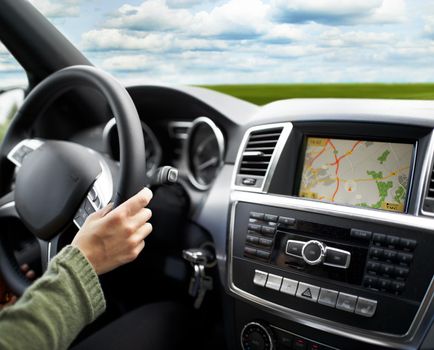 Cropped shot of a person traveling by car using the on-board GPS to navigate.