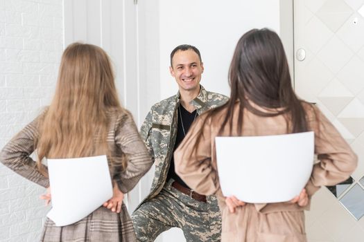 Family Greeting Military Father Home On Leave.