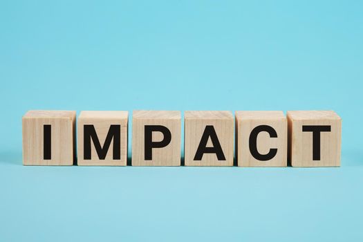 IMPACT word on wood blocks concept. Business improvement, personal development, and growth concept. IMPACT word written on wooden cubes. IMPACT word written on wooden blocks. Business concept