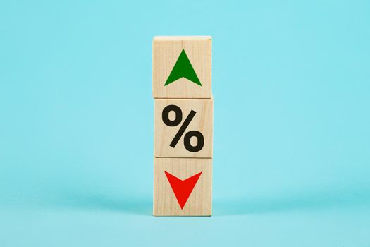 Cube block with percentage symbol icon. Interest rate financial and mortgage rates concept. Wood cube change arrow down to up. Interest rate, stocks, ranking. Business and finance concept