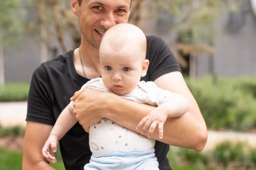 baby boy outdoor playing with father