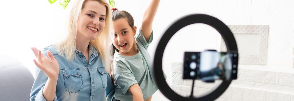 blogger woman records video with round lamp.