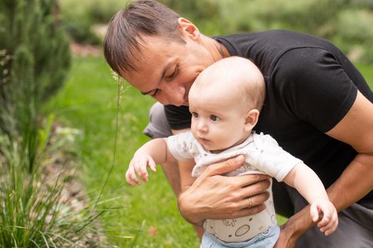 Summer portrait of beautiful baby on the lawn.