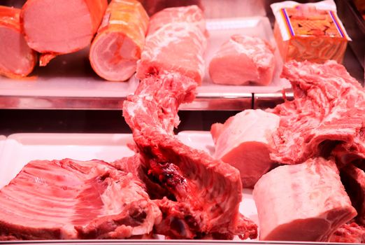 Pieces of different types of Meat for sale at a market stall inside the Central Market of Alicante