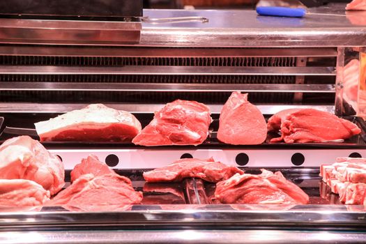 Pieces of different types of Meat for sale at a market stall inside the Central Market of Alicante