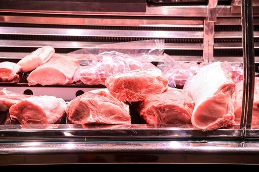 Pieces of different types of Meat for sale at a market stall inside the Central Market of Alicante