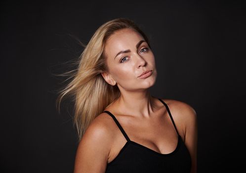 Beautiful attractive blonde body positive Caucasian woman in black underwear posing against dark background with copy ad space. Confidence, self acceptance, healthy lifestyle. Love your body concept