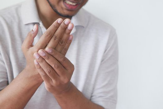 man suffering pain in hand close up .