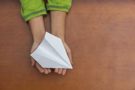paper airplane in children's hands