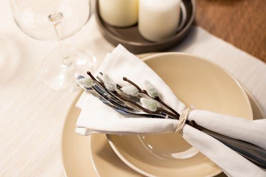 Festive Easter table setting with painted eggs and floral decor on light grey background, flat lay. Space for text