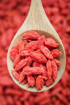 The Dried Chinese wolfberries or goji berries in wooden spoon.