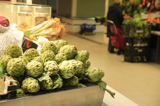 Artichokes for sale at a farmer market stall in the Central Market of Alicante