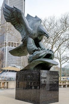 American Eagle Statue, Battery Park, Manhattan, New York City, low angle side view during winter day with overcast, vertical
