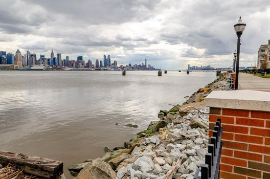 View of Manhattan from the Other side of Hudson River, New Jersey during winter, fence and street light in front, horizontal