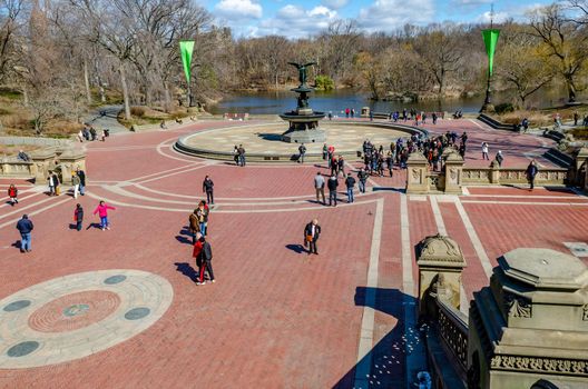 Bethesda Fountain with Angel of the Waters Sculpture wide angle shot, aerial view Central Park New York, lots of people around the fountain, lake in the background during daylight in winter, horizontal