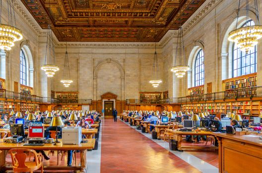 People and students sitting in a large Hall in the New York Public Library to read and learn, NYC, United States, Horizontal