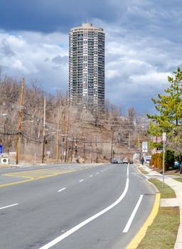 The Stonehenge on the Palisades, Residential Building, Skyscraper at North Bergen, New Jersey  Sky, during overcast on a winter day, view from the distance with city street in the front, vertical